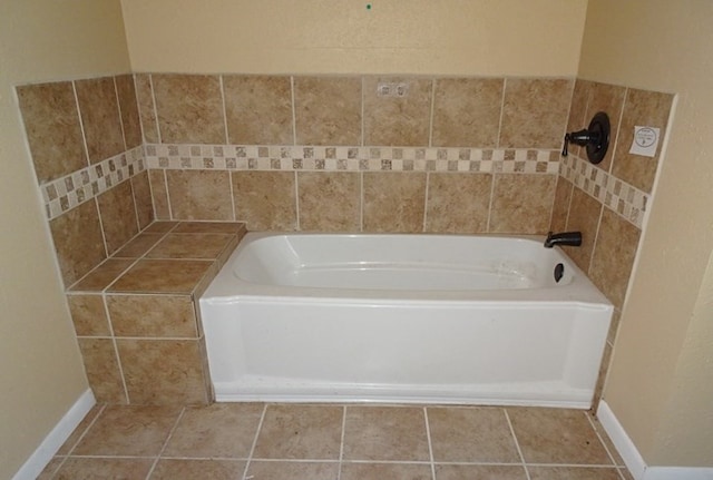 bathroom featuring tile patterned floors and a bath