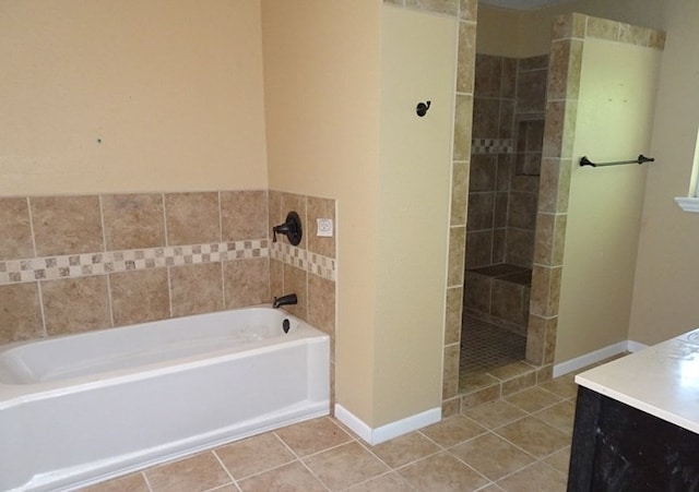 bathroom featuring a tub to relax in, tile patterned flooring, and vanity