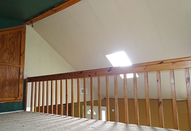 staircase with lofted ceiling with skylight and carpet floors