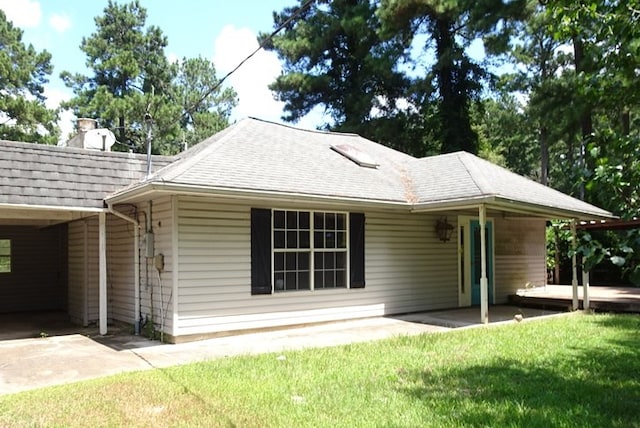 rear view of property featuring a lawn