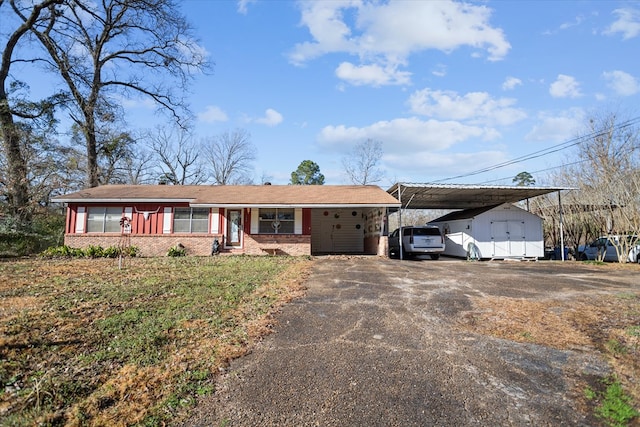 ranch-style home featuring a carport and covered porch