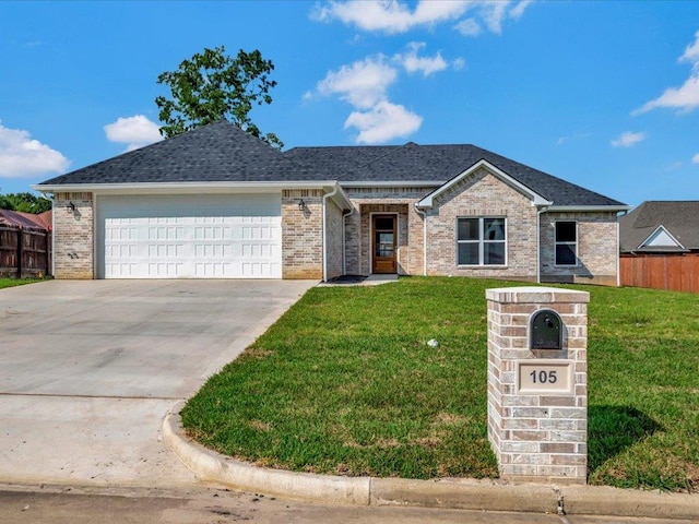 ranch-style house with a front yard and a garage