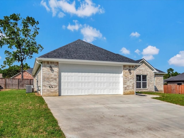 ranch-style house featuring central AC unit, a garage, and a front yard