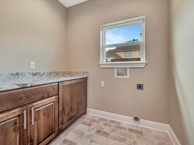 laundry room with washer hookup, electric dryer hookup, and cabinets