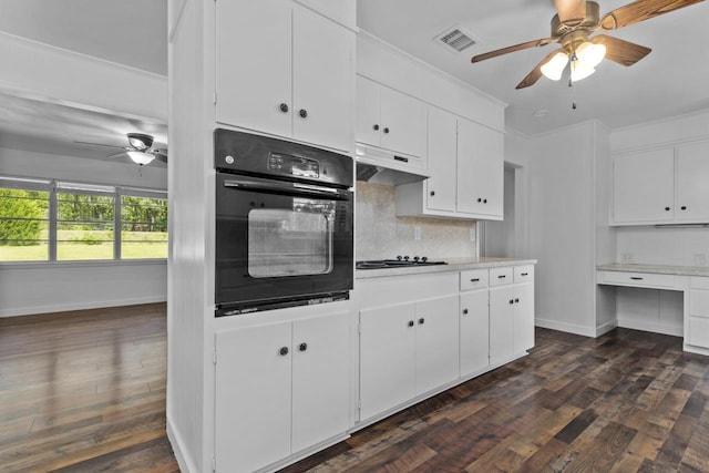 kitchen featuring visible vents, a ceiling fan, dark wood-style floors, under cabinet range hood, and black appliances