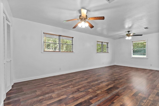 unfurnished bedroom featuring a ceiling fan, a closet, baseboards, and dark wood finished floors