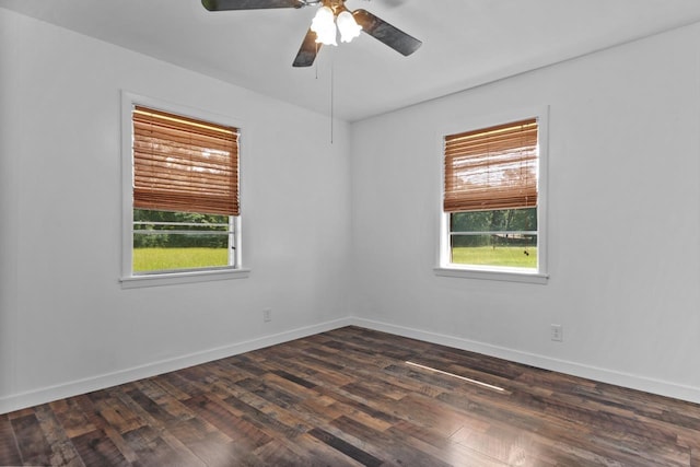 unfurnished room with dark wood-style floors, baseboards, and a ceiling fan