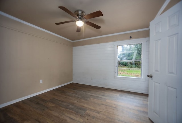 spare room featuring dark hardwood / wood-style flooring, ceiling fan, and ornamental molding