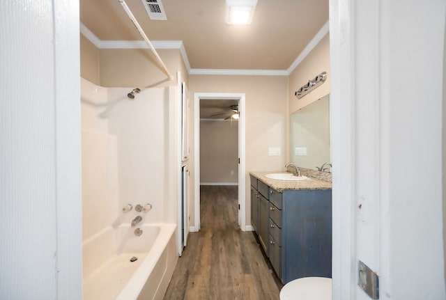 full bathroom with ceiling fan, wood-type flooring, vanity, bathtub / shower combination, and ornamental molding