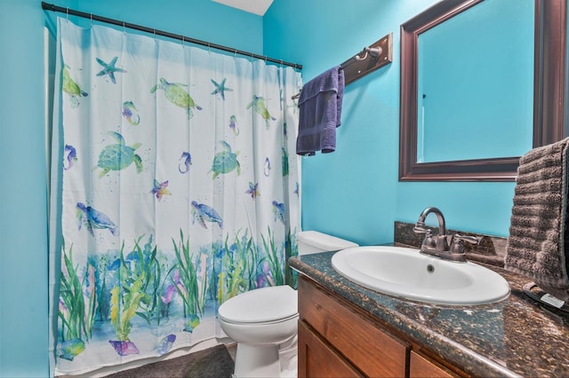 bathroom with vanity, a shower with shower curtain, and toilet