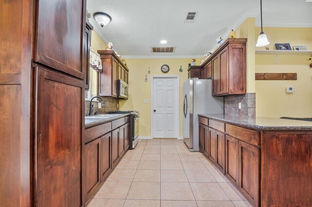 kitchen with stainless steel appliances, crown molding, hanging light fixtures, and tasteful backsplash