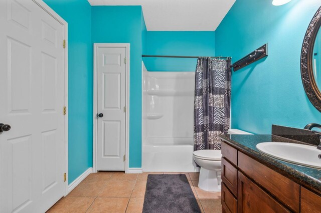 full bathroom with tile patterned floors, vanity, shower / tub combo, and toilet