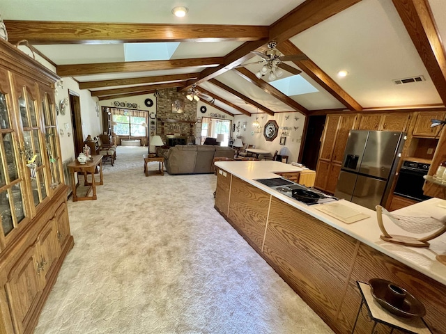 kitchen with stainless steel fridge, ceiling fan, oven, and light carpet