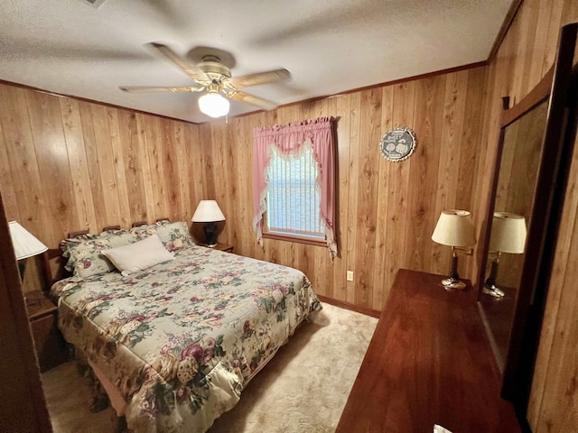 bedroom featuring carpet, a textured ceiling, ceiling fan, and wooden walls