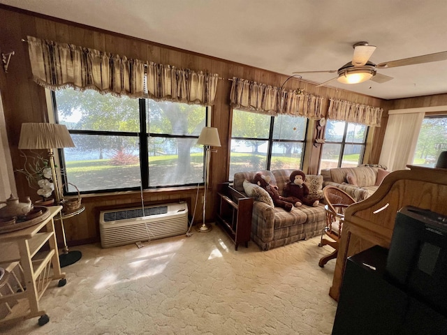 living room featuring a wall mounted air conditioner, ceiling fan, wood walls, and light colored carpet