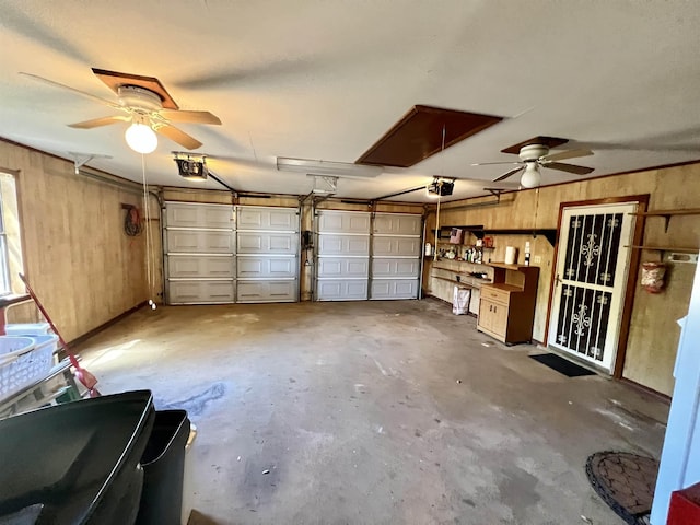 garage featuring wooden walls and a garage door opener