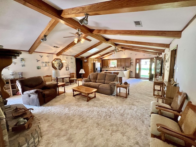 carpeted living room with vaulted ceiling with beams and ceiling fan