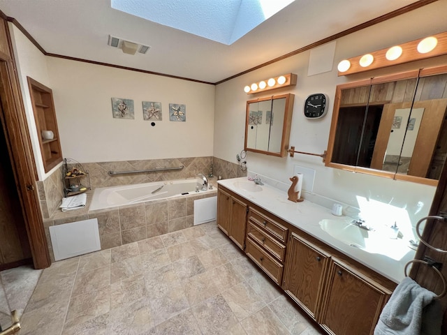 bathroom featuring vanity, ornamental molding, tiled tub, and a skylight