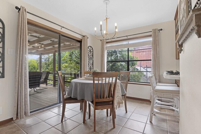 dining area featuring plenty of natural light, an inviting chandelier, and tile patterned flooring