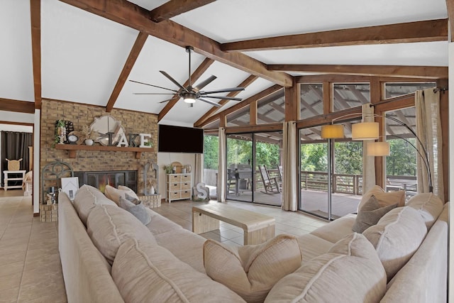 living room featuring ceiling fan, a fireplace, light tile patterned floors, and lofted ceiling with beams