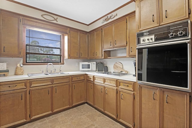 217 County Road 223, Brookeland, TX 75931 - kitchen with white appliances, light countertops, brown cabinetry, and ornamental molding