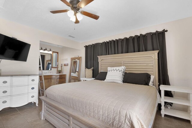 tiled bedroom with ceiling fan