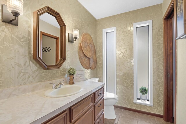 bathroom with tile patterned floors, vanity, and toilet