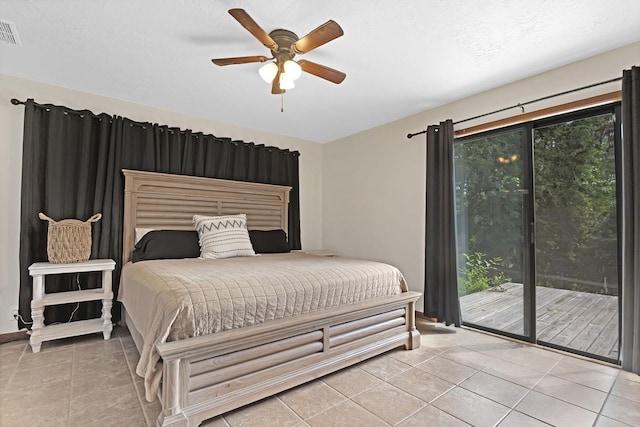 bedroom with ceiling fan, light tile patterned flooring, access to exterior, and a textured ceiling