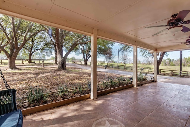 view of patio featuring ceiling fan and a rural view