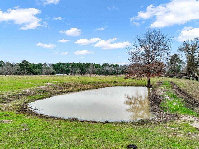 view of yard featuring a rural view and a water view