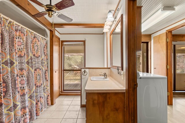 bathroom with tile patterned flooring, washer / dryer, vanity, and ceiling fan