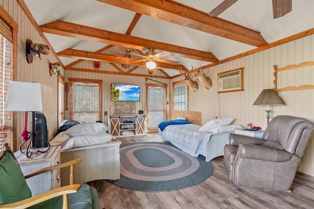 living room with hardwood / wood-style floors, ceiling fan, beam ceiling, and a healthy amount of sunlight