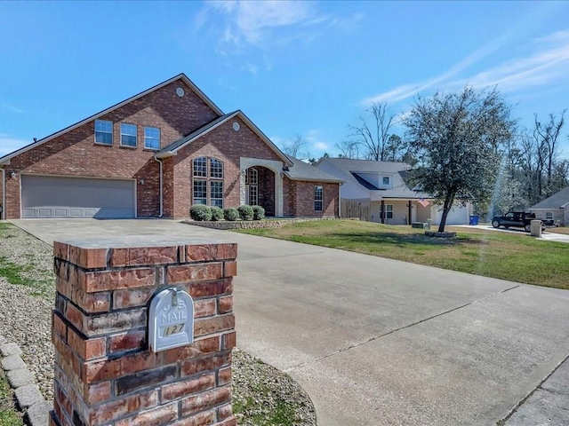 view of front of house with a garage and a front lawn