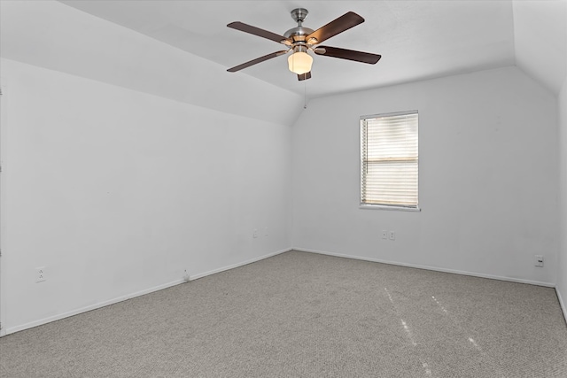 carpeted empty room featuring ceiling fan and vaulted ceiling