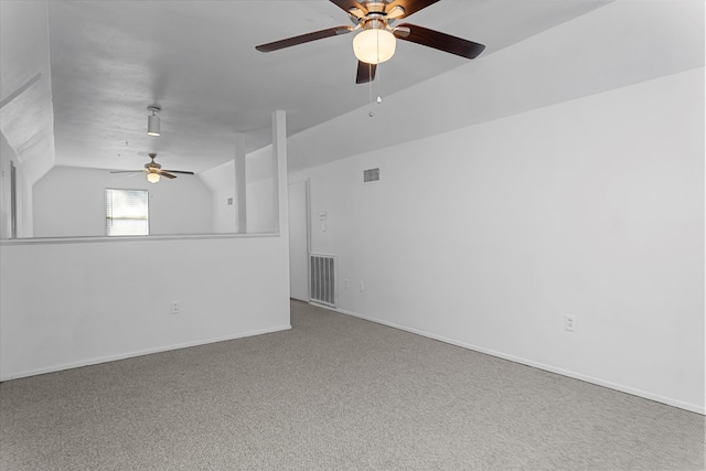 carpeted empty room featuring vaulted ceiling and ceiling fan