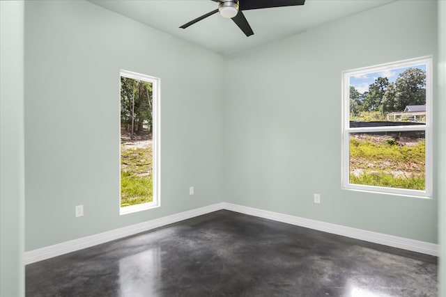 spare room featuring ceiling fan and a healthy amount of sunlight