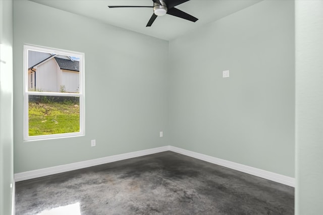 unfurnished room featuring dark carpet and ceiling fan