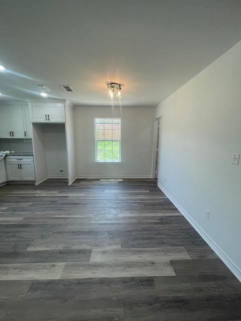 unfurnished dining area with dark hardwood / wood-style flooring