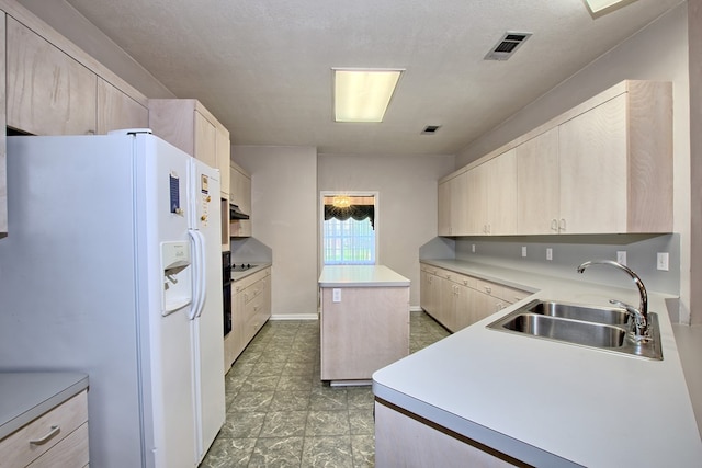 kitchen with light brown cabinets, white refrigerator with ice dispenser, sink, a textured ceiling, and a kitchen island