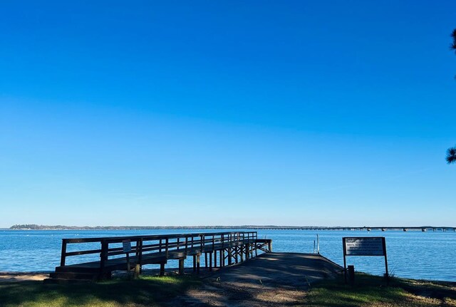view of dock with a pier and a water view