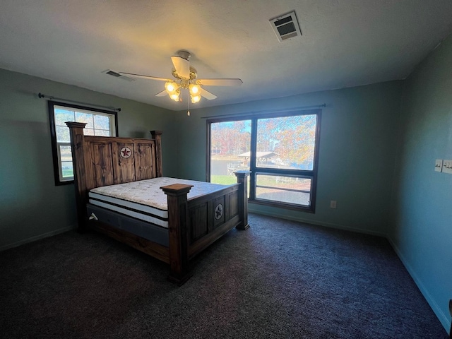 bedroom featuring dark carpet and ceiling fan