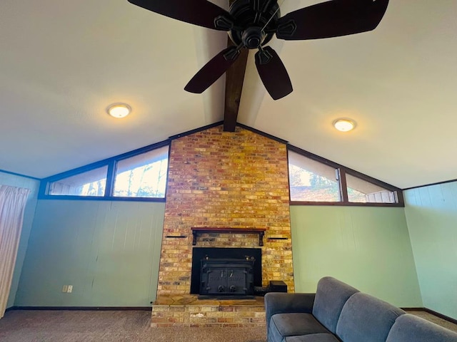 living area with carpet, a fireplace, baseboards, ceiling fan, and vaulted ceiling with beams