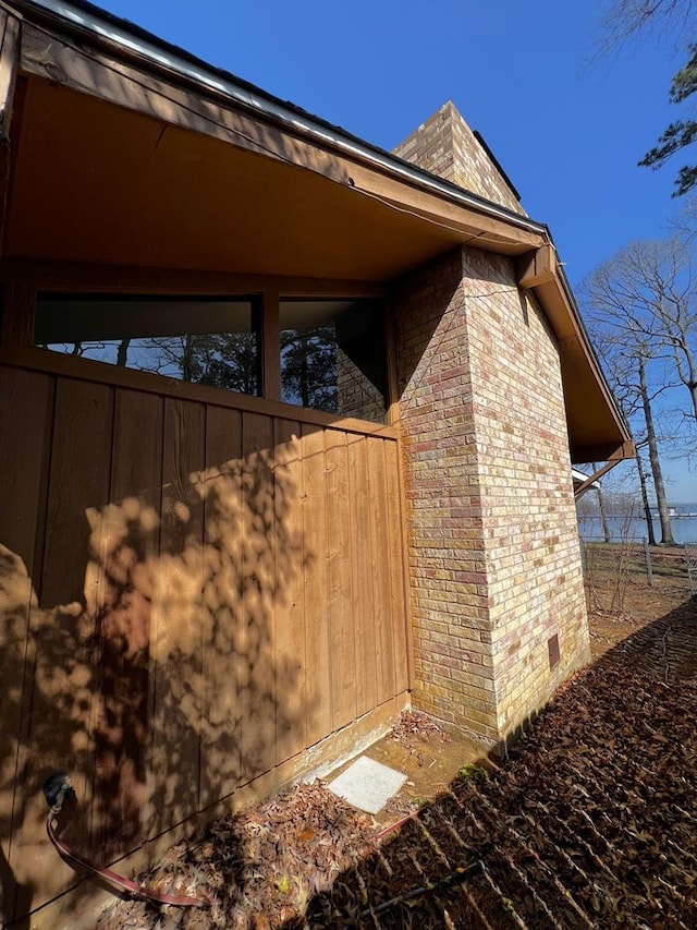 view of side of property featuring brick siding