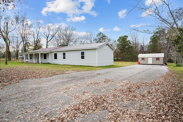 view of property exterior with a yard and an outdoor structure