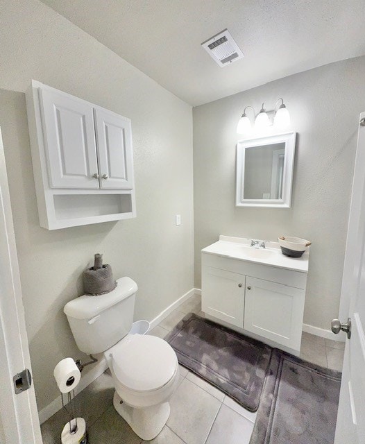 bathroom featuring vanity, toilet, and tile patterned flooring