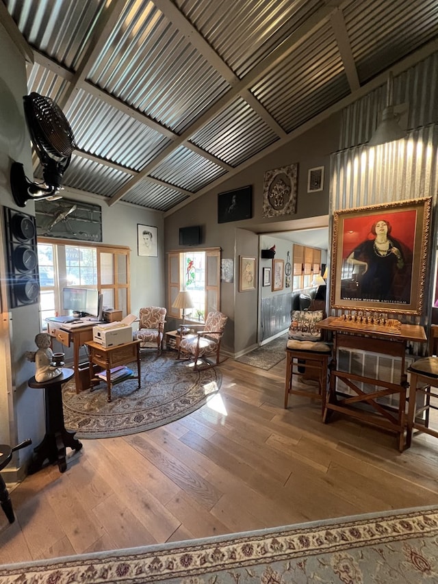 living room with hardwood / wood-style floors and lofted ceiling