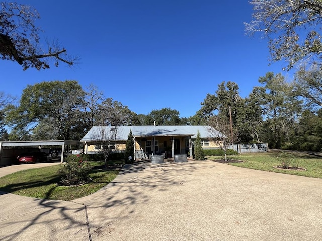 ranch-style home featuring a carport and a front yard