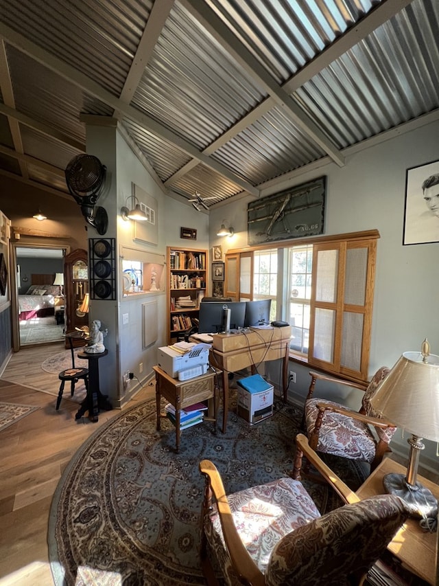 living room featuring hardwood / wood-style floors and lofted ceiling with beams