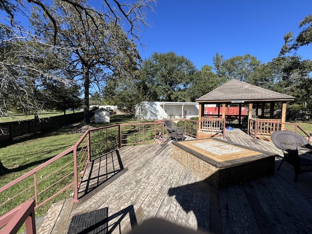 wooden terrace featuring a gazebo and a yard