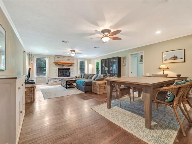 1318 Sue Dr, Lufkin, TX 75901 - living area featuring crown molding, wood finished floors, a stone fireplace, a ceiling fan, and recessed lighting